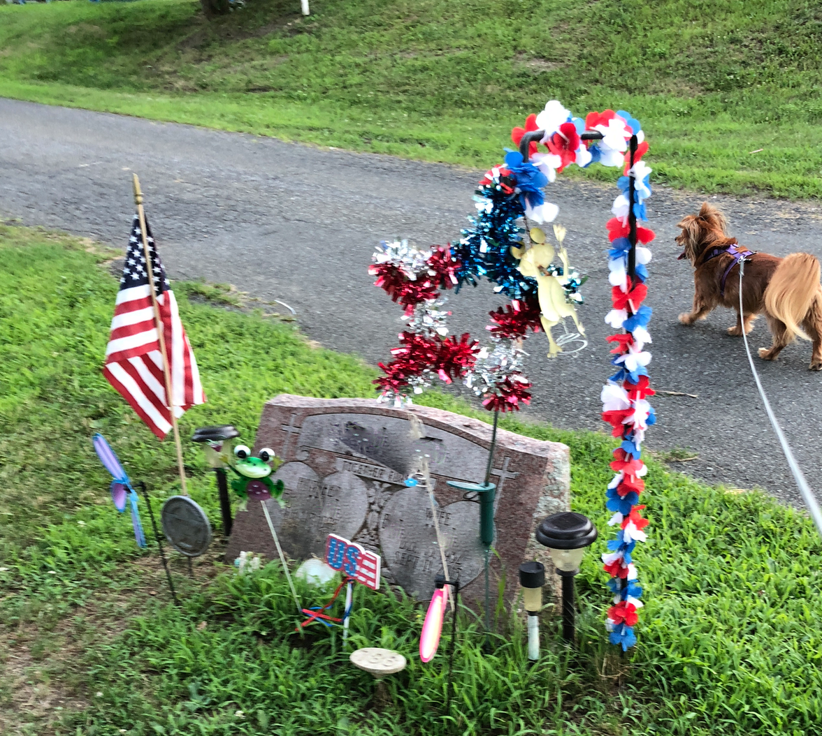 a decorated gravesite in the local cemetery